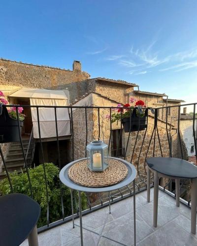 a small table with a candle on a balcony at WelcHome Vitorchiano Guest House in Vitorchiano