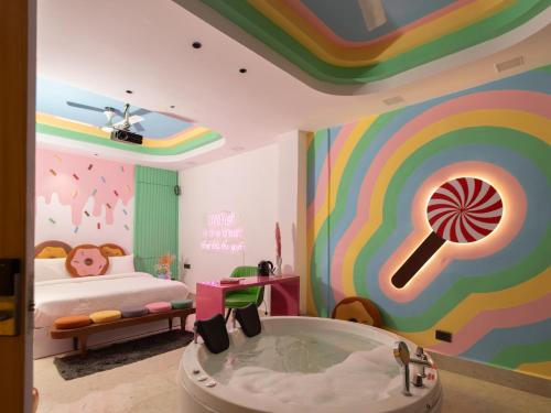 a childs bedroom with a large mural of a candy bar at Orsom Stay Rooms with Jacuzzi Sector 53 Gurgaon in Gurgaon