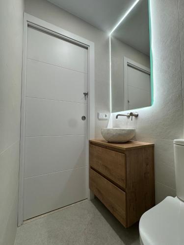 a bathroom with a sink and a mirror at Petit Paradís in Sant Antoni de Calonge