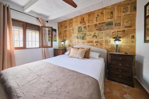 a bedroom with a bed and a wooden wall at Casa Mathilda in Fornes