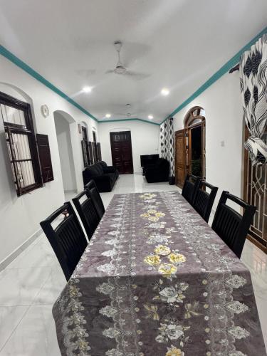 a dining room with a table and chairs at Radiance Inn in Jaffna