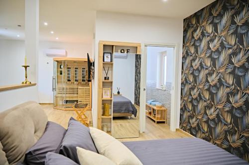 a living room with a couch and a bedroom at RG MAISON - Suite 29 in Morino
