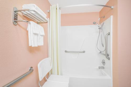 a bathroom with a white toilet and a shower at Super 8 by Wyndham Shelbyville in Shelbyville