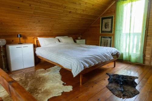 a bedroom with a bed in a wooden cabin at Apartma Dobnik in Mozirje