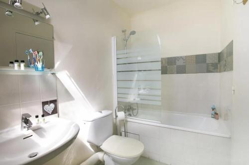 a bathroom with a toilet and a sink and a shower at Eurocéan Adonis Budget in Guérande