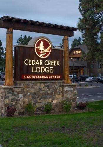 a sign for a cedar creek lodge and conference center at Cedar Creek Lodge & Conference Center in Columbia Falls