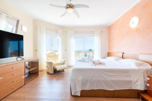 a bedroom with a large bed with a ceiling fan at Can Martinez in Llucmajor