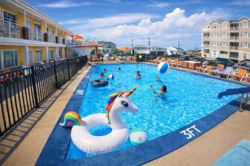 a pool at a resort with people in the water at Sea Chest Motel in Wildwood Crest