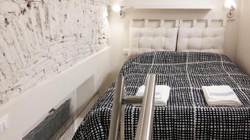 a bedroom with a bed with black and white sheets at A Dream in Florence in Florence
