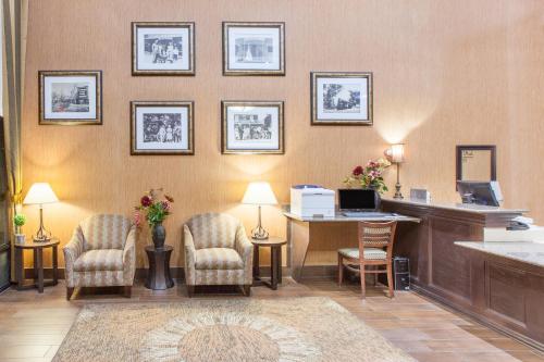 an office with a desk and chairs and a computer at Baymont by Wyndham Branson - On the Strip in Branson
