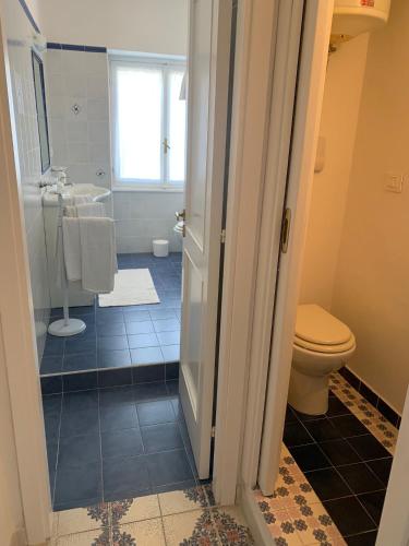 a bathroom with a toilet and a sink at CasaFiumicello in Maratea
