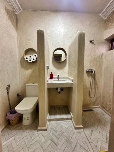 a bathroom with a sink and a toilet and a shower at Surf and Tribe in Tamraght Ouzdar