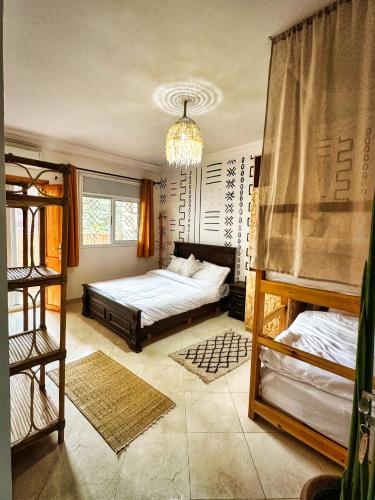 a bedroom with two bunk beds and a chandelier at Surf and Tribe in Tamraght Ouzdar
