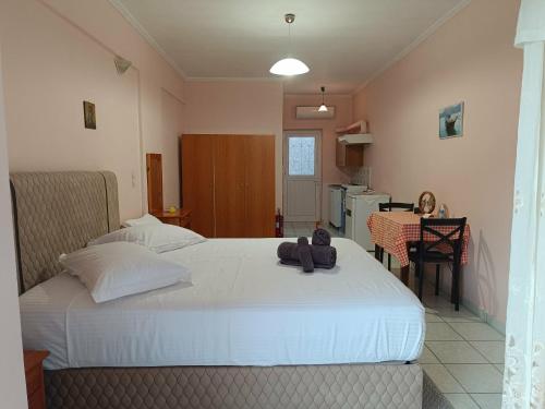 a bedroom with a bed with a teddy bear on it at Geni Bay 2 in Lefkada