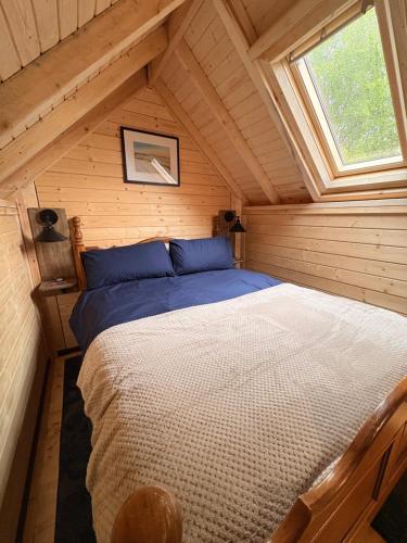 a bedroom with a bed in a attic at Glenwood glamping pod in Morar