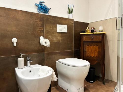 a bathroom with a toilet and a sink at Camera con Vista in Cervia
