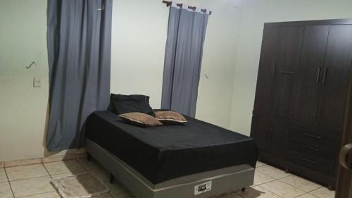 a bed with two pillows on it in a bedroom at Quarto casal standart max in Ribeirão Preto