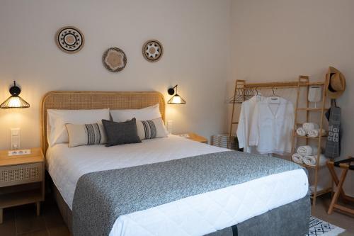 a bedroom with a large bed in a room at Lagonisi Olive Retreat in Kalívia Thorikoú