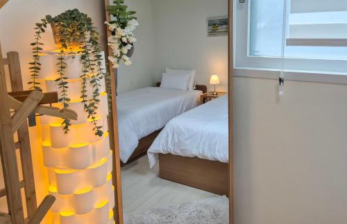 a room with two beds and a room with a mirror at Fresh Stay in Seoul