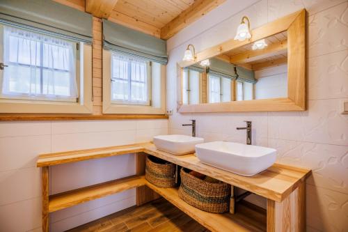 a bathroom with two sinks and a mirror at Roubenka Pod Oblohou in Dolní Morava