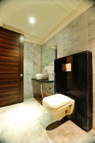 a bathroom with a toilet and a sink at Bless Inn in Prayagraj