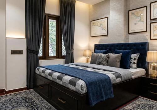 a bedroom with a king sized bed with a blue headboard at RADHA Homestay in Mathura