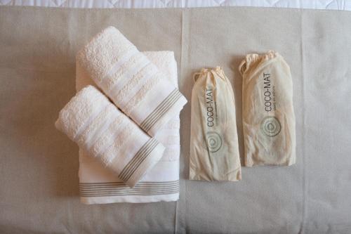 two towels sitting on top of a table at Lagonisi Olive Retreat in Kalívia Thorikoú