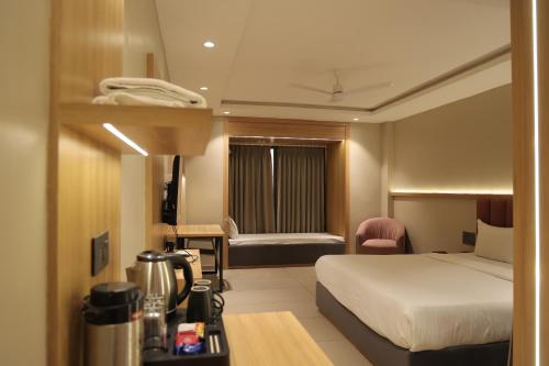 a hotel room with a bed and a desk at Sai Krishna Hill View Resort in Pawārkhera