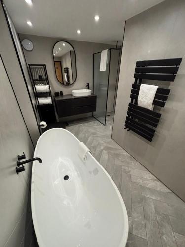 a bathroom with a white sink and a mirror at Raasay Apartment in Fort William