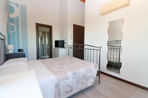 a bedroom with a bed and a painting on the wall at Casale Papa Country Village in Loreto