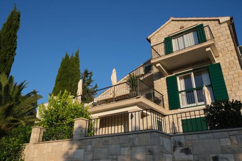 a large house with a fence in front of it at Villa Mila in Splitska