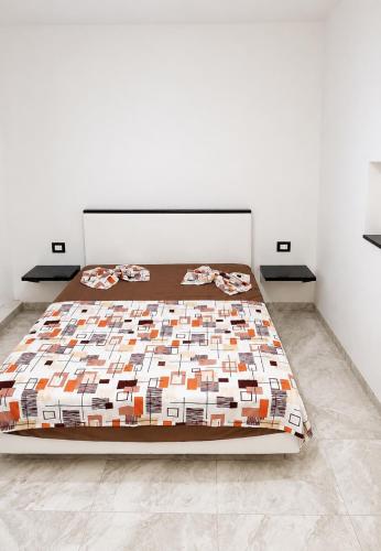 a bedroom with a bed with a quilt on it at Casa del Mar Residences in Kelibia