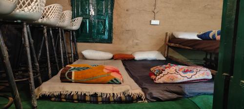 a room with two bunk beds with pillows on them at Heritage hut in Vashisht