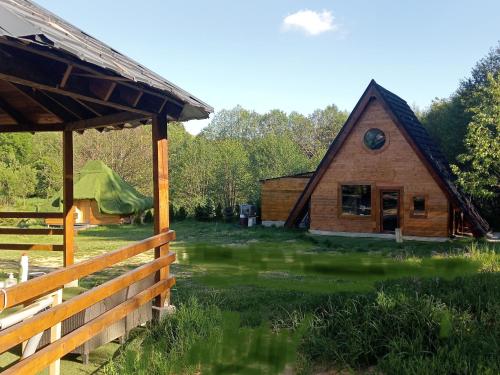 a barn with a fence in front of it at Maria - Brebu Nou in Brebu Nou