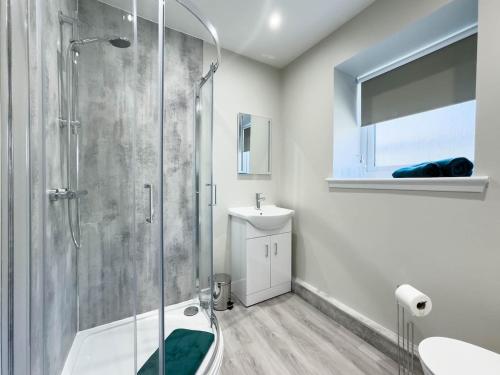 a bathroom with a shower and a sink at Almanythie Snug, Peterhead in Peterhead