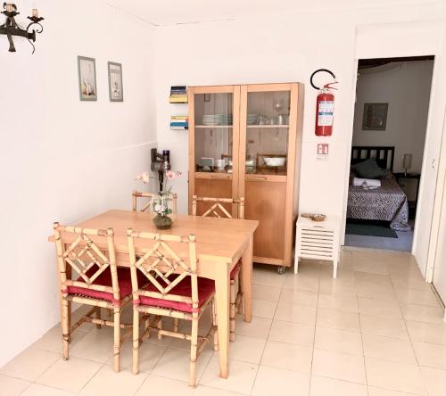 a dining room with a wooden table and chairs at CiroMenotti62 in Marina di Carrara