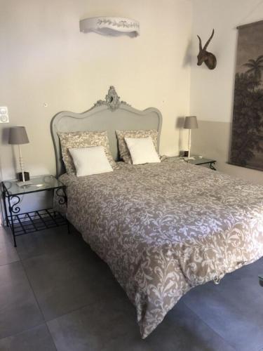 a bedroom with a large bed with two tables at Clos Sainte Marguerite in Lambesc