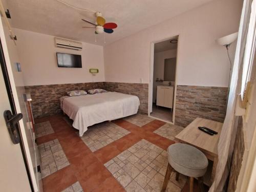 a bedroom with a bed and a table in a room at Casita Casa la Rambla in La Romana