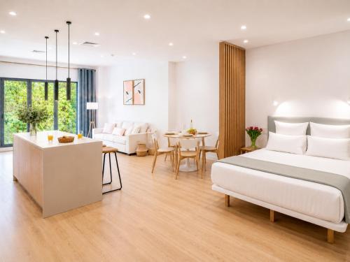 a bedroom with a bed and a living room at Paseo Suites Hotel in Madrid