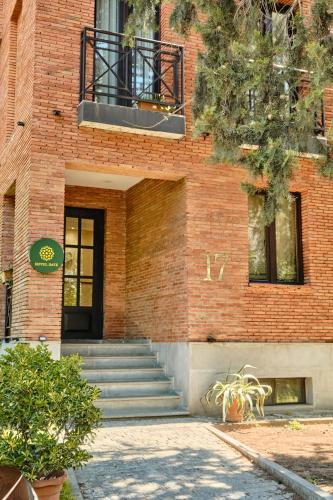 a brick building with stairs leading up to a door at Hotel Date in Tbilisi City