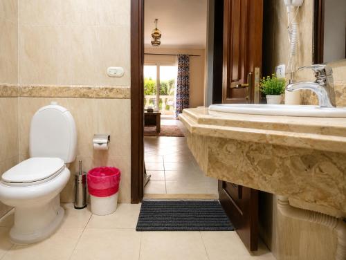 a bathroom with a toilet and a sink at Casa Dòdò - Sunny Lakes Compound in Sharm El Sheikh