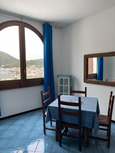 a dining room with a table and chairs and a window at Oltremare Residence Hotel in Lipari