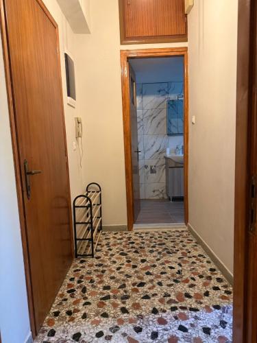 a hallway with a door and a tile floor at ChaKo Stay Solutions Studio in Lamía