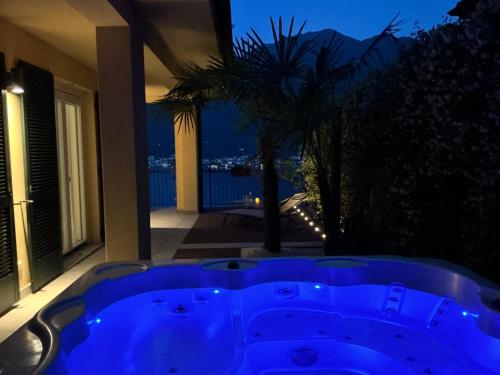 a blue bath tub in front of a house at Colonno Panoramica Lago Di Como in Colonno