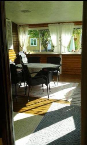 a dining room with a table and chairs at Schwedentraum in Burseryd