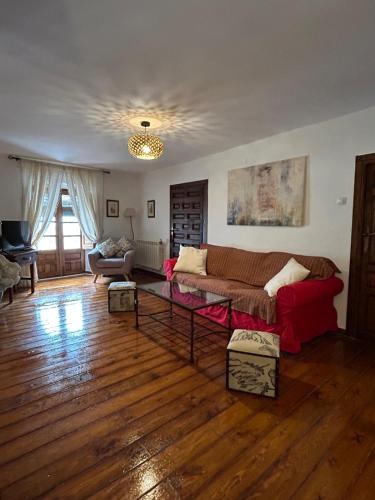 a living room with a couch and a table at La Salera - Casa Rural in Saelices de la Sal