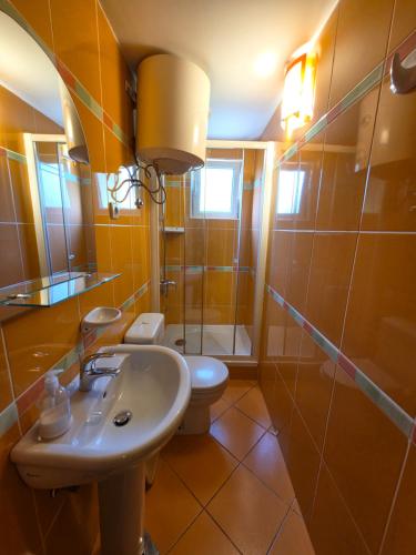 a bathroom with a sink and a toilet at Apartmani Dado in Sutomore