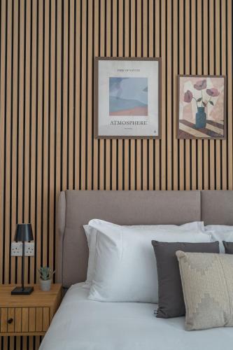 a bedroom with a bed and a striped wall at Slimiza in Sliema