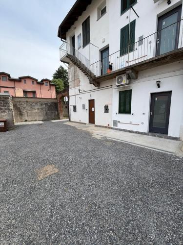 an empty street in front of a white building at Volta 15 - 20' Rho Fiera Milano in Senago