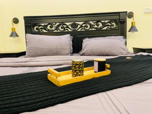 a bedroom with two beds with a black and white headboard at Hestia by Gunner Lodges in Patriata